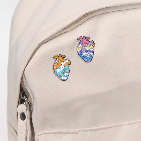 Heart enamel pins on backpack.webp