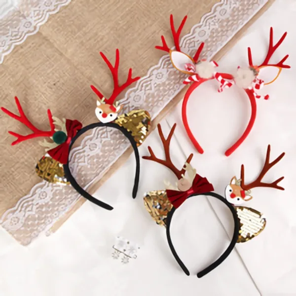Four different Christmas reindeer antler headbands laid out on a lace-trimmed surface